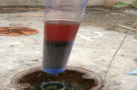Water Sample from a Monitoring Well showing Petrolium Product at the Bottom of the Sample